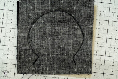 black fabric on cutting mat showing construction steps of zip pouch