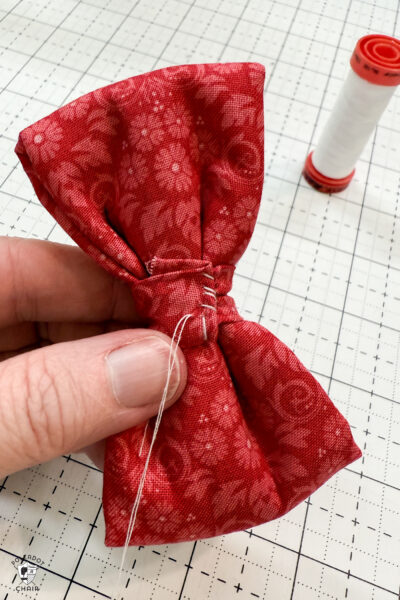 red fabric on cutting mat with showing construction steps of zip pouch