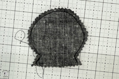 black fabric on cutting mat showing construction steps of zip pouch