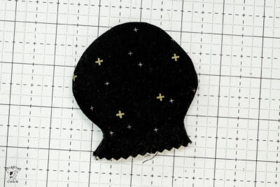 black fabric on cutting mat showing construction steps of zip pouch