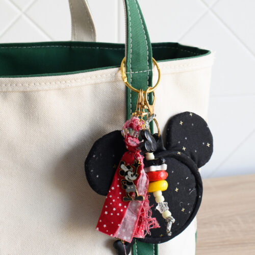 mickey shaped bag charm on canvas tote bag