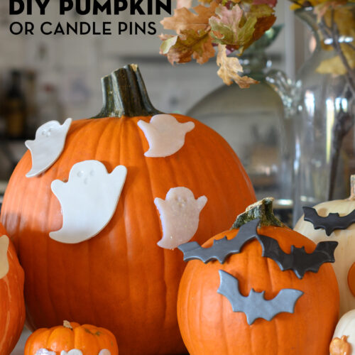 pumpkins on kitchen counter with bat and ghost candle pins