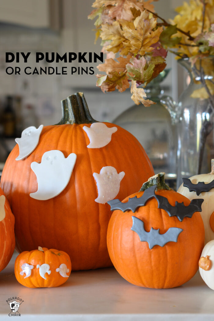 pumpkins on kitchen counter with bat and ghost candle pins