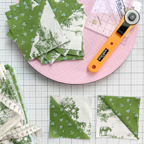 green and white half square triangles on white cutting mat