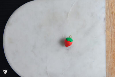 Clay strawberry on cutting board