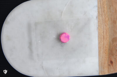 Squished clay ball on cutting board