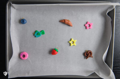 Clay charms on parchment paper