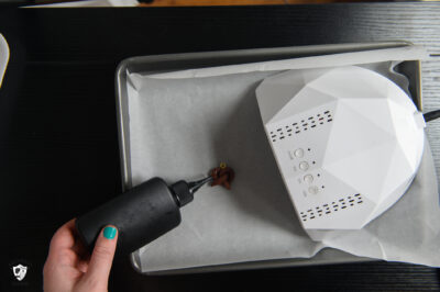 Clay charm being UV cured