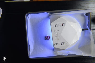 Clay charm being UV cured