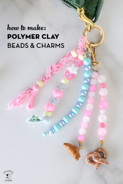 close up of pink and blue bag charms on white marble counter