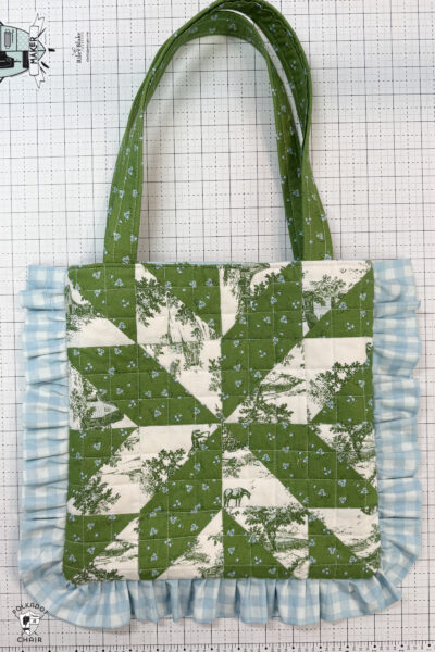 gray and white tote bag on white cutting mat
