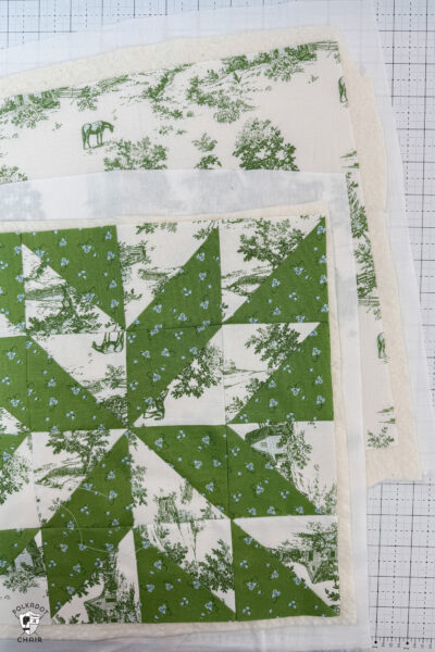 quilted pieces of fabric on white cutting mat