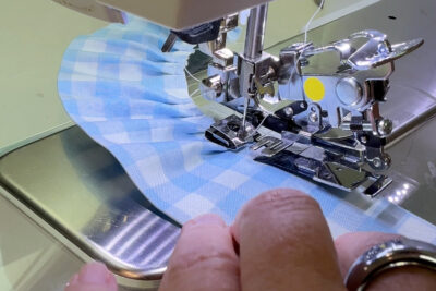 blue fabric under ruffler foot