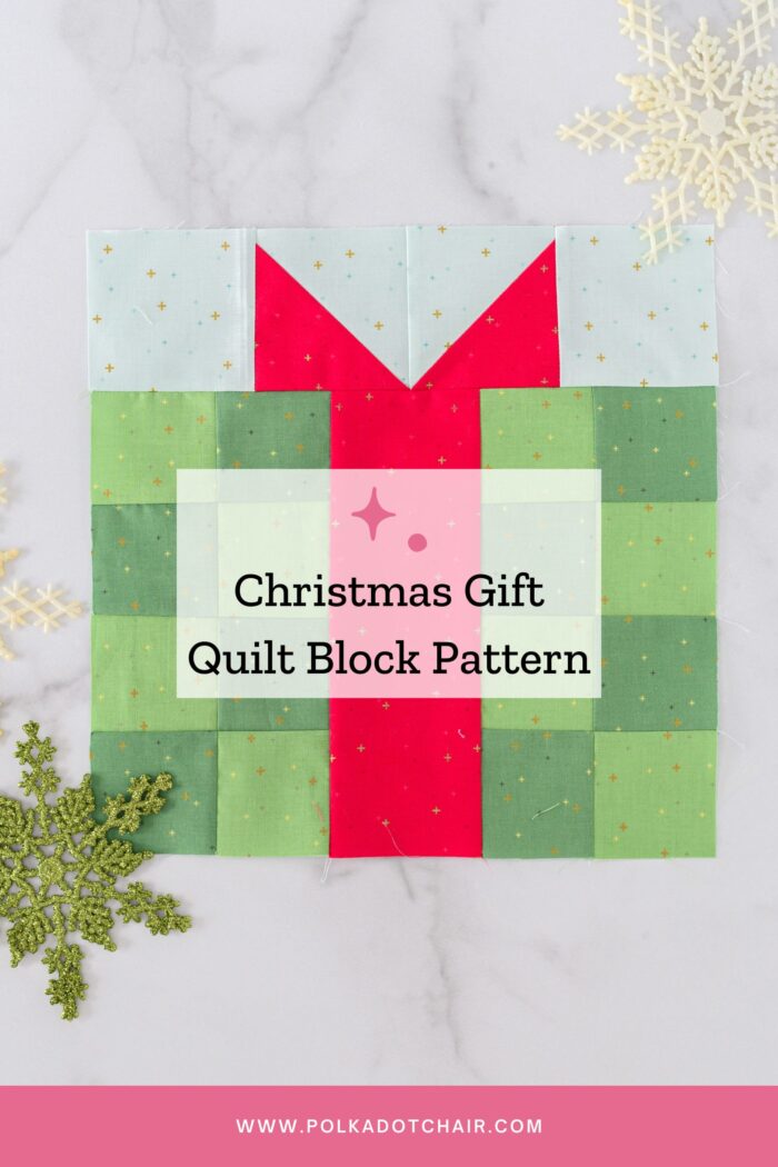 green and red present quilt block on white tabletop