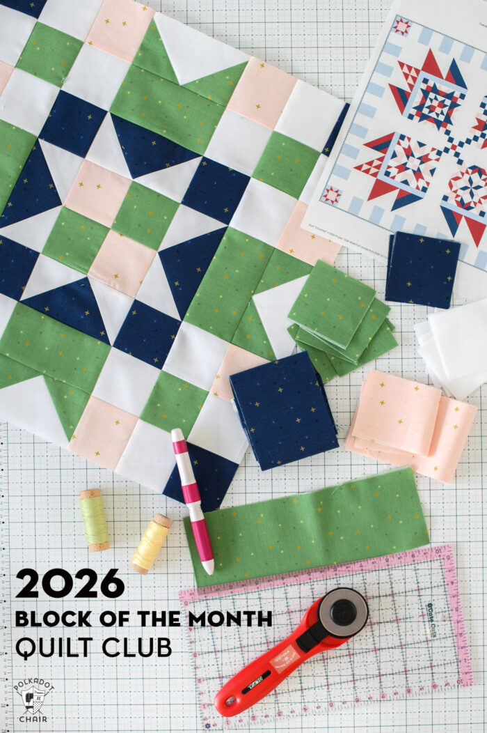 Green, navy, pink and white quilt block and fabric and quilt notions on white cutting mat