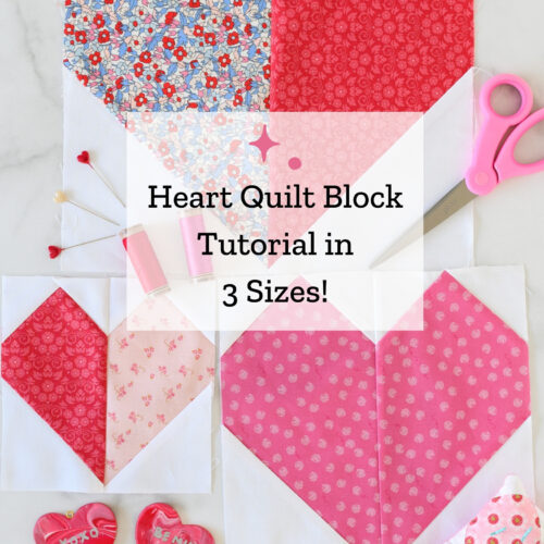 Three heart quilt blocks in pink, red and white on white table with sewing notions