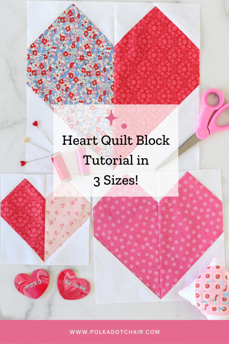 Three heart quilt blocks in pink, red and white on white table with sewing notions