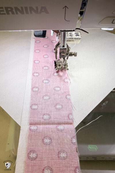 fabric strips on paper under sewing machine foot