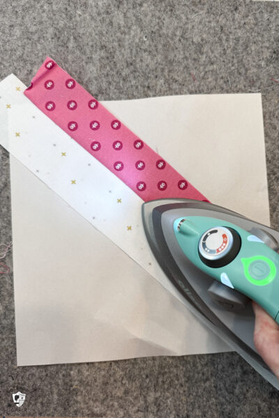 iron pressing fabric strips on wool pressing mat
