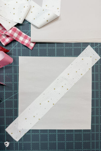 white fabric on white fabric square on cutting mat