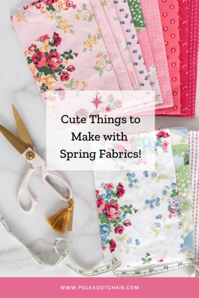 stack of pink and white floral spring fabrics on white table top with scissors and tape measure