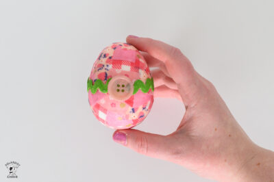 pink egg with green ricrac around the center and a pink button in the center.