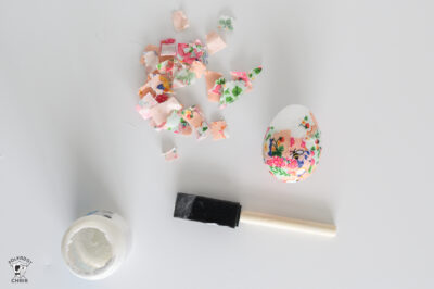 white foam egg covered in pink fabric pieces with fabric scraps in a pile to the side.