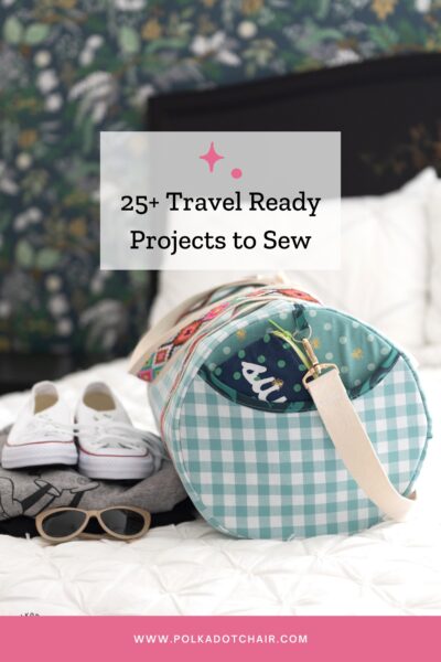 duffle bag on bed with white comforter and shoes and sweatshirt