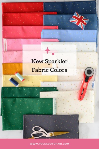 swatches of sparkler fabrics in bright colors on white table with sewing notions