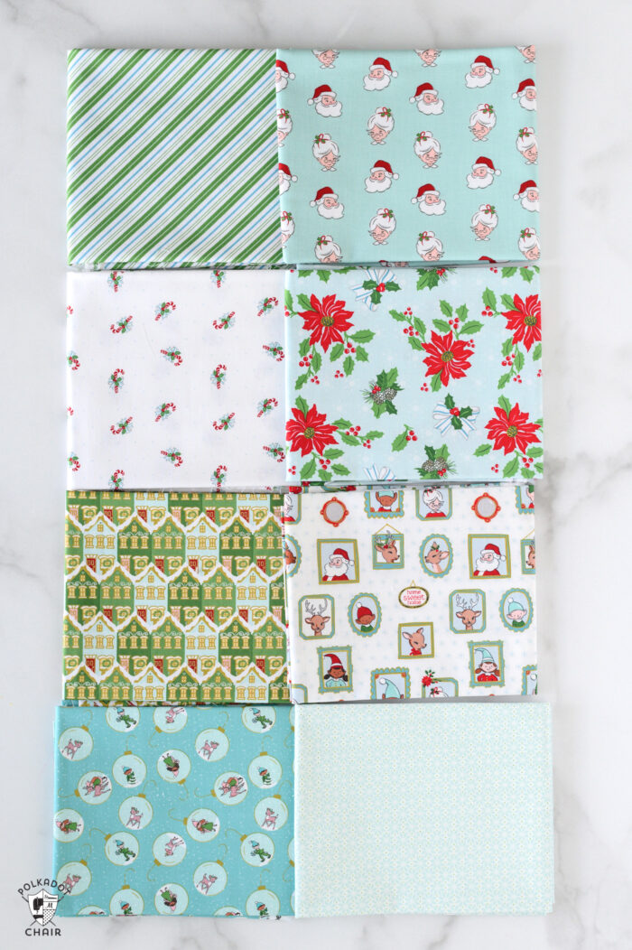 aqua and white christmas fabric folded on white table