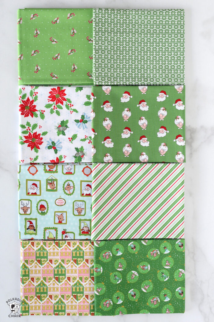 green and aqua christmas fabric folded on white table