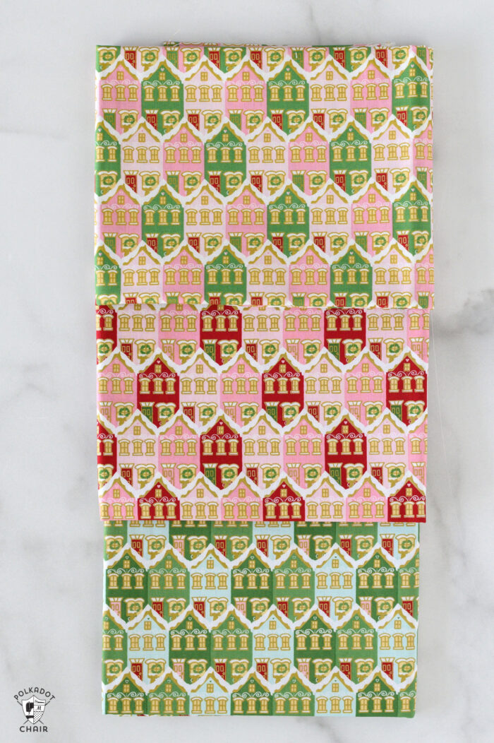 red and pink christmas fabric folded on white table