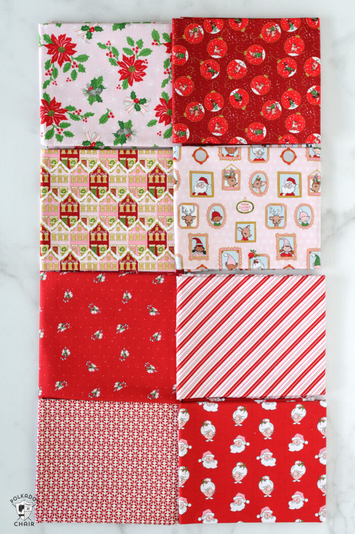 red and pink christmas fabric folded on white table