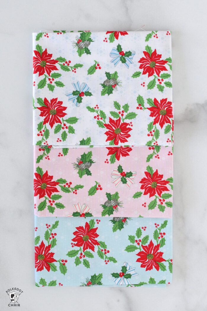 red and pink christmas fabric folded on white table