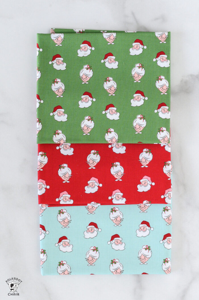 red and pink christmas fabric folded on white table