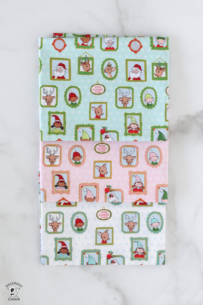 red and pink christmas fabric folded on white table