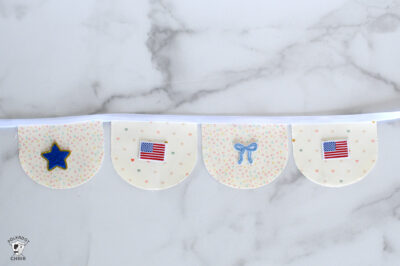 Polka dot baby bunting featuring American flags and a star for patriotic decor.