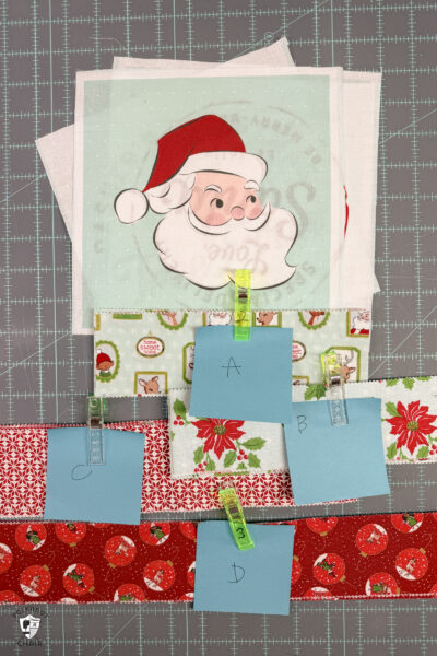 stacks of christmas fabric cut on cutting table