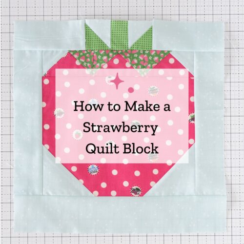 sewn strawberry quilt block on white cutting mat with text overlay