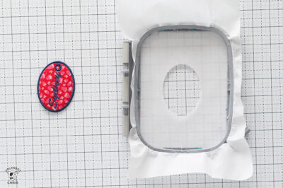 Embroidery hoop with polka dot pattern on fabric for chair design.