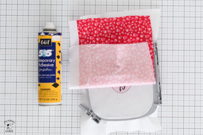 Craft supplies for polka dot chair project with adhesive and fabric.