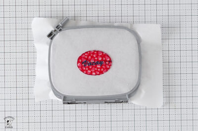 Red polka dot embroidery design with the name Hayden on white fabric.