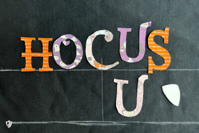 close up of Hocus Pocus Halloween letters on black sweatshirt